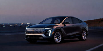 Cadillac LYRIQ electric SUV parked on open road showing full exterior design